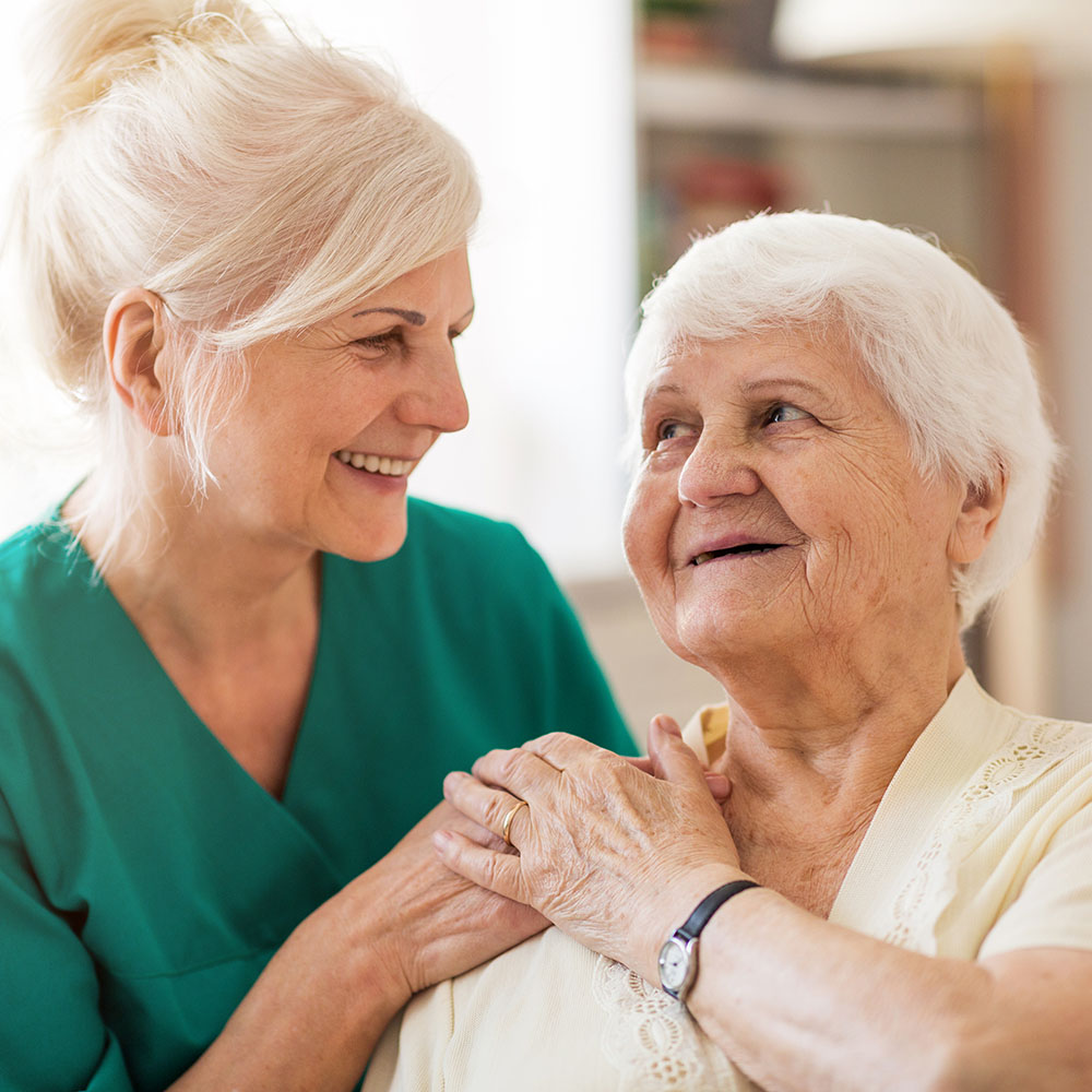 Home caregiver and senior adult woman