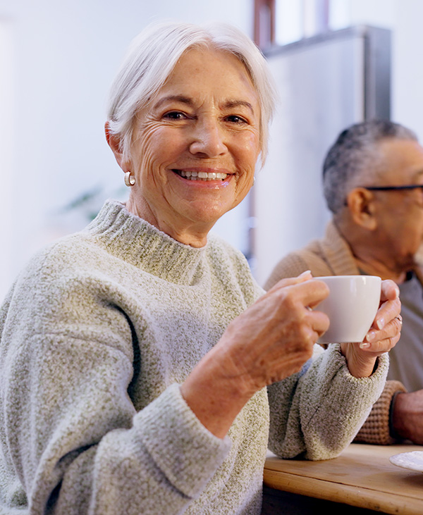 Portrait, tea party and a group of senior people in the living room of a community home for a social. Friends, smile or retirement with elderly men and women together in an apartment for a visit